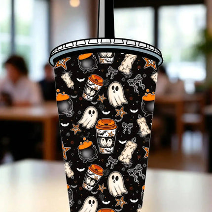 A Halloween-themed cup with a black background and various spooky and festive elements such as ghost, bats, stars, and a pumpkin.
