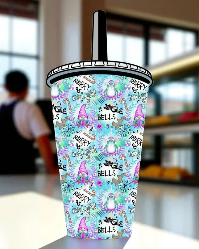 A colorful, patterned beverage cup with various Christmas-themed illustrations and text, including the words "Merry Bright" and "Jingle Bells".